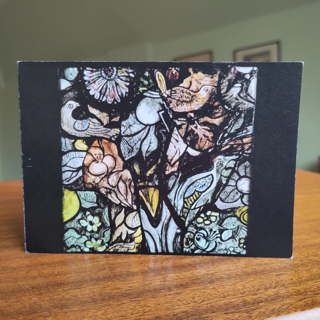 Handmade Christmas card with a stained glass panel including birds and flowers