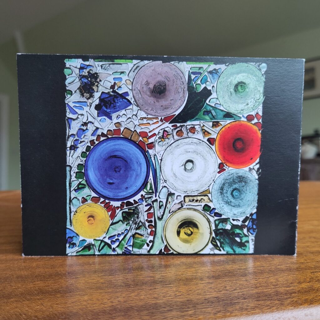 Handmade Christmas card showing an abstract composition in stained glass, including a house martin